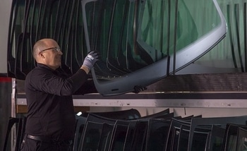facilitates_replacement A man takes a windshield glass from his stock