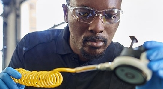 A certified technician repairs a windshield