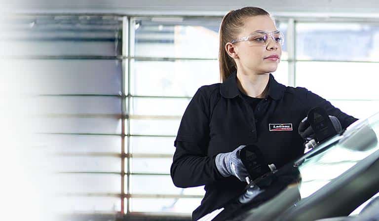 A woman from Lebeau replaces a windshield