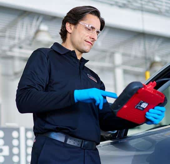 A Lebeau employee recalibrates the front camera with a device